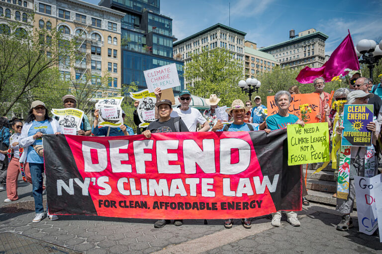 Participants seen holding a banner at the protest. Members